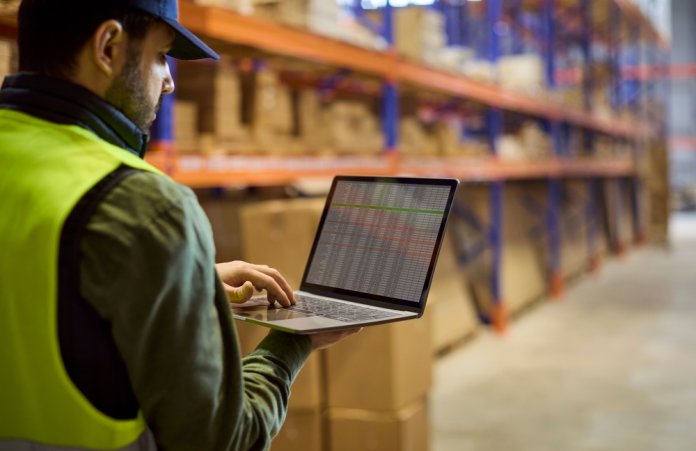 Warehouse,Inventory,Worker,Uses,Laptop,For,Stock.,He,Checks,Goods