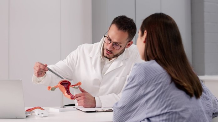 Young,Male,Gynecologist,Uses,Laptop,To,Explain,Ovarian,Anatomy,To